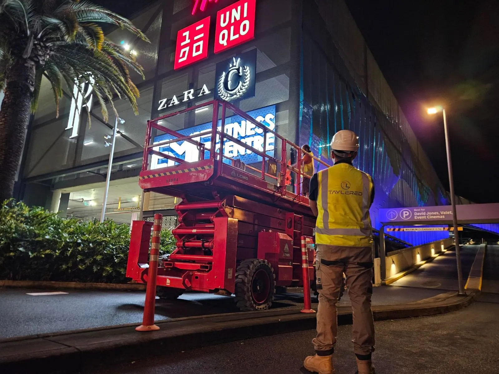 Taylered supervisor overseeing night works at a shopping centre car park